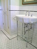 Which wall tiles in a bathroom with a patterned floor