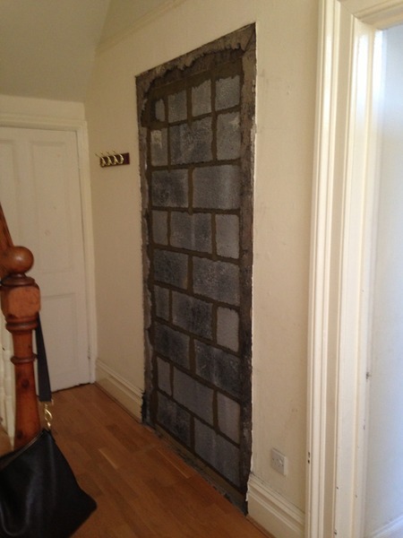 knocking through a previously bricked up door and reinstating old dividing wall