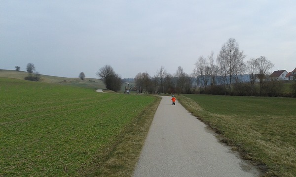Cyclists  riding two or three abreast down country lanes.