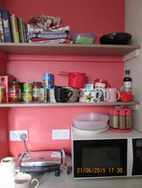 What can you store in a tiny gap next to the cooker?