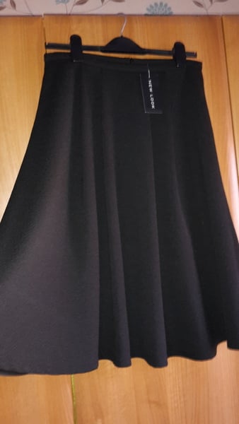 What top could I wear with a black a line midi?