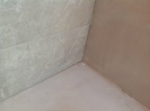 Caulk or grout where the tiles meet the ceiling/walls?