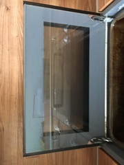 How can I clean my oven door glass?