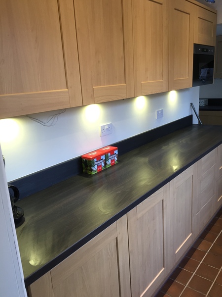 Contemporary kitchen with black worktop on island