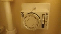 How do you adjust a water heater timer?