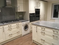 Contemporary kitchen with black worktop on island