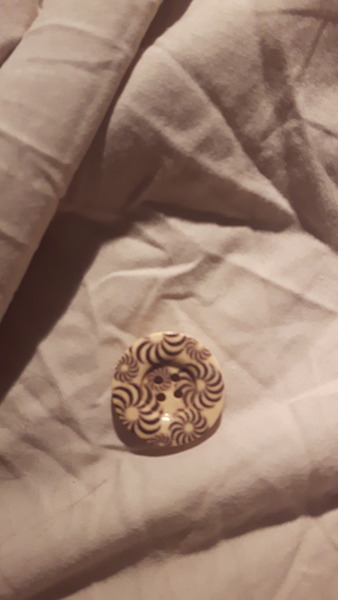 Cream buttons on a black wool coat?