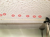 How do I find a solid beam (to screw something into) in a ceiling?