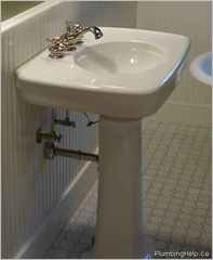 Painting black waste pipe behind sink