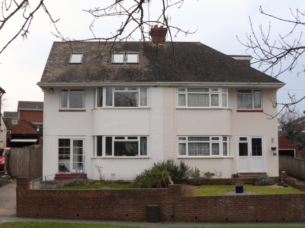 Hipped roof at the front of the house, gable at the back - does it look odd?