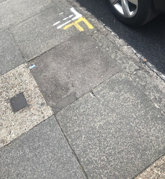Neighbour spray painting pavement for their access