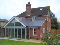 Hipped roof at the front of the house, gable at the back - does it look odd?