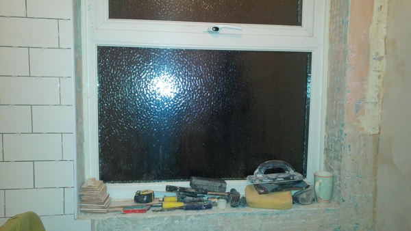 Tiles in bathroom around window