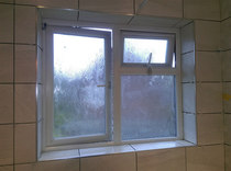 Tiles in bathroom around window