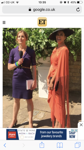Who wore the orange dress and cape with a black hat yesterday?  She looked stunning but can find no mention of who she is anywhere.
