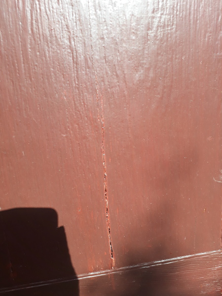 Wooden door with a vertical crack