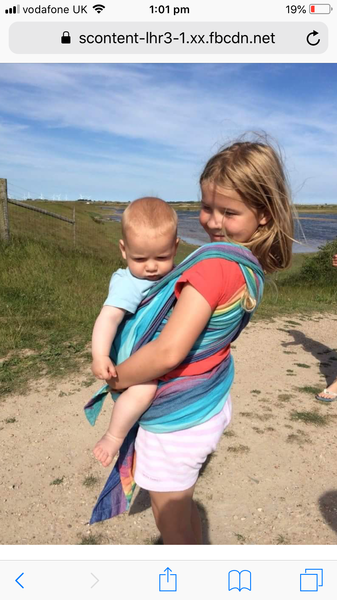 Sibling holding the baby