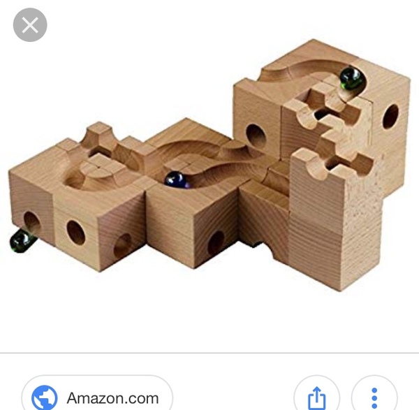 9 year old and wooden train track.