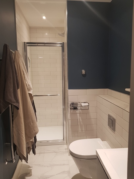 Shower enclosure or walk in behind a wall?