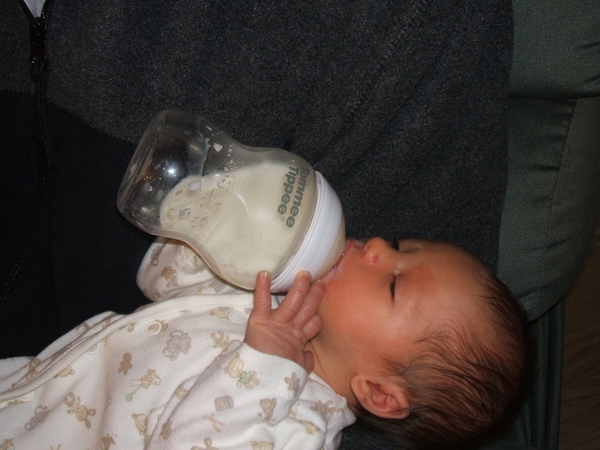 2 month old baby held and drank from bottle...