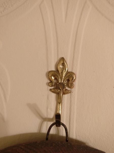 Screw covers for hanging mirror from a chain.