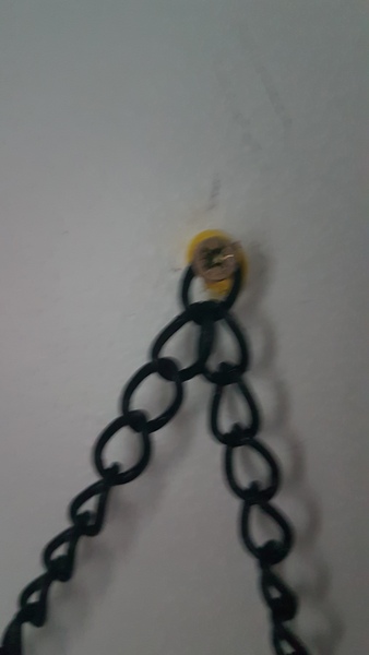 Screw covers for hanging mirror from a chain.