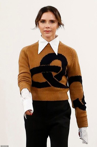 Victoria Beckham looks happy...