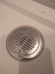 Pipe running across shower drain?