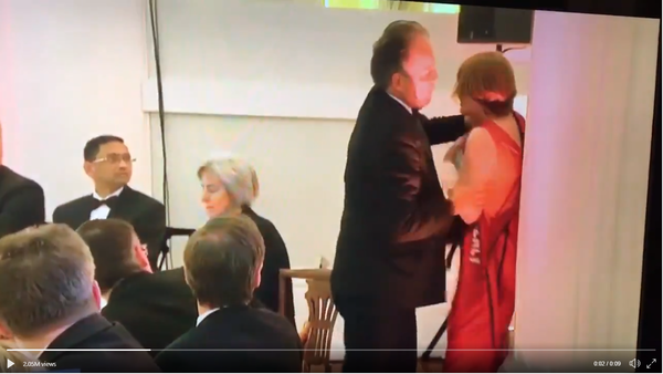 MP Mark Field grabs female protester by throat