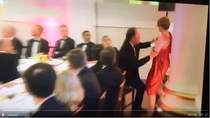 MP Mark Field grabs female protester by throat