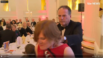 MP Mark Field grabs female protester by throat