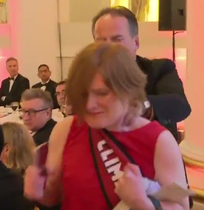 MP Mark Field grabs female protester by throat