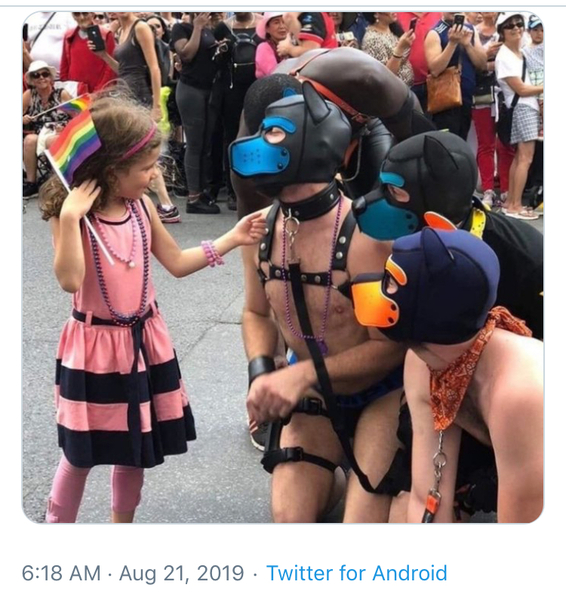 Pup play fans dance for children at Pride