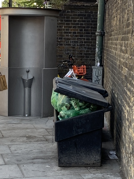 Open urinals on a London street corner, in daytime