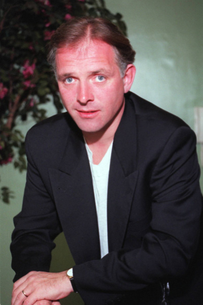 Do you have the photo of Rik Mayall signing something..