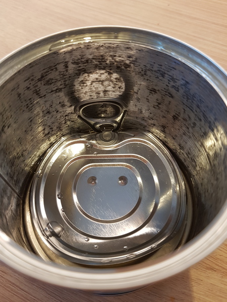 Beans tin black inside, aibu to eat the contents?