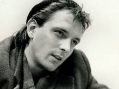 Do you have the photo of Rik Mayall signing something..