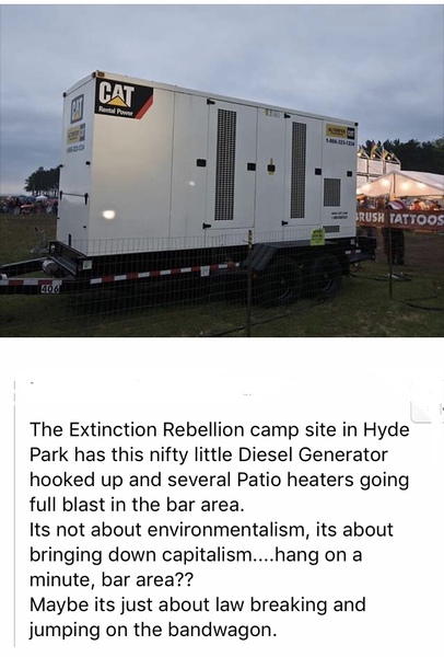 Good  God  Extinction Rebellion   blocking  a funeral  hearse.