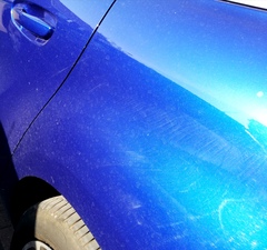Neighbour splattering my car while washing their own