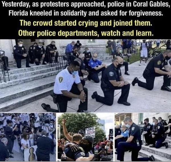 Police officers kneeling with protesters over George floyd