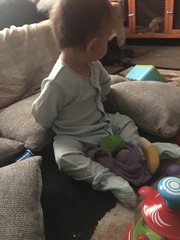 12 month old, twisting arms behind back?