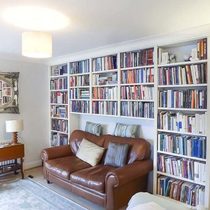 Book shelves above a sofa.