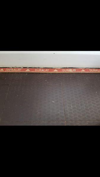 Black boards/laminate under carpet... what is it?