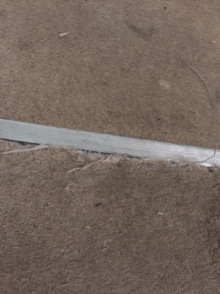 Manky carpet coming away from grips.  Advice please.