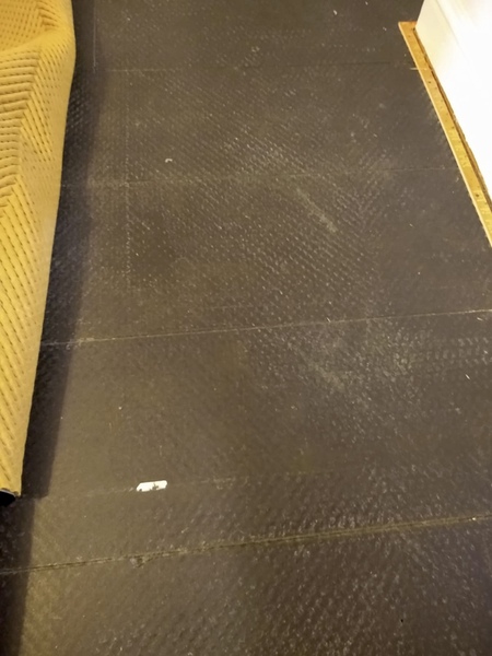 Black boards/laminate under carpet... what is it?