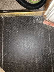 Black boards/laminate under carpet... what is it?