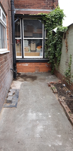 Uneven concrete back yard - cheap fix?