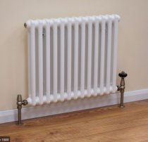 Laminate planks under radiators - which direction?
