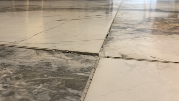 Floor tiles grout crack and uneven