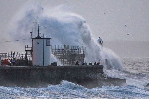 Idiots on harbour walls in this storm